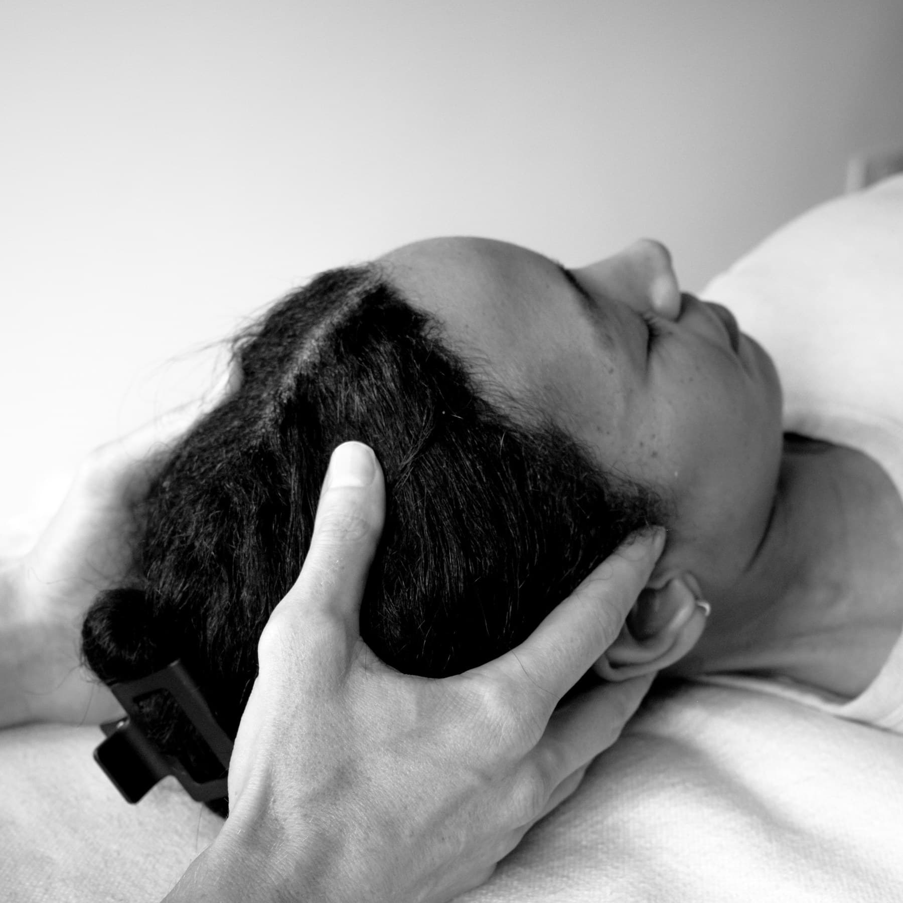 Craniosacral therapy — gentle hold on the head and neck